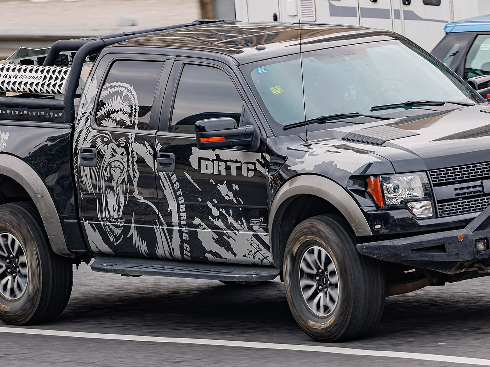 Black Ford Raptor with printed graphics along the side