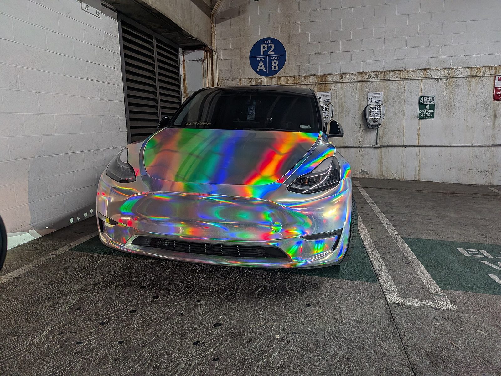 Tesla Model 3 in rainbow holographic chrome wrap