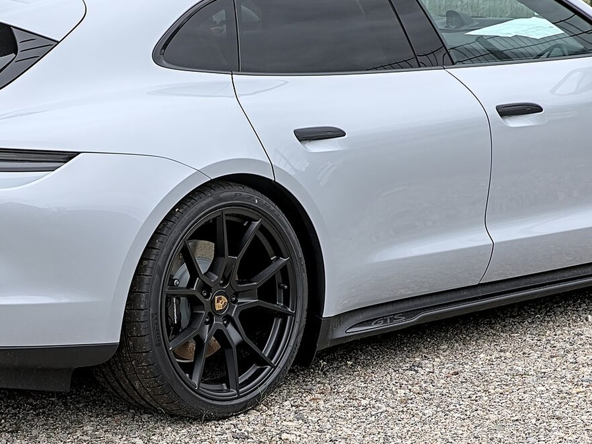 White Porsche Taycan with blacked-out trim and wheels